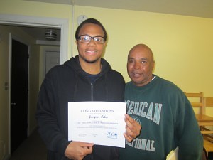 Jack Towles, president of the youth group at Robinson Gardens Apartments, and Jimmie Mitchell, SHA youth engagement coordinator, at a recent celebration of the YEAH! Network youth leadership program.