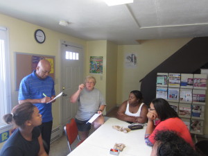 Springfield Housing Authority Youth Engagement Coordinator Jimmie Mitchell and Talk/Read/Succeed! Outreach Coordinator Lynne Cimino give tips and advice to working teens at Robinson Gardens Apartments.