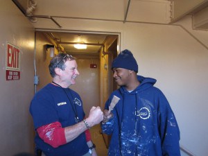 Roca crew supervisor Jack Cascio, left, and Aaron Betts of Springfield unite in their enthusiasm for the painting work at Riverview Apartments.
