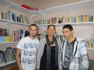 SHA grants coordinator Lidya Rodriguez, center, stands between successful GED candidates Francisco Estrada, 19, and Jonathan Ferreras, 18. Both young men live in Springfield.
