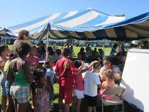 Robinson Gardens children line up for face painting at a T/R/S! back-to-school event.