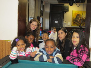 Children in the after-school program at Moxon Apartments make a fine audience as young poets perform their lines.