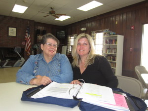 Forest Park Manor resident Corinne Turcotte reviews health insurance options with Candra Cripps, SHA resident services coordinator who is a certified SHINE counselor.