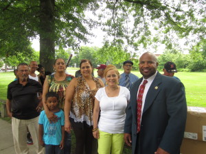 John Brown, aide to Hampden County Sheriff Michael J. Ashe, in the foreground, with City Councilor Zaida Luna and Saab Court resident Sandra Rodriguez, along with members of the Saab Court Lions baseball team.
