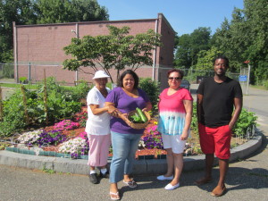 Jennie Lane gardeners Maria Valdes, Jessica Quiñonez, Ana Fuentes and T.J. Hall stand before their creation.