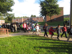 Childen, parents, educators and organizers head from Sullivan Apartments to Boland School on the 'Walking School Bus.'