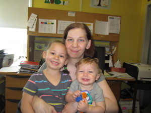 Robinson Gardens resident Kelly Robblets holds her children, Trinity Cousin, 4, and Gabriel Cousin, 1.