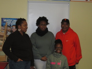 Mom Sincia Perrin and her daughters with SHA Youth Engagement Coordinator Jimmie Mitchell.