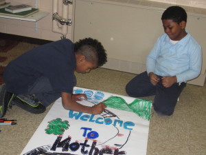 Davyian Walker, 9, and Demarion Carter, 7, create the poster for the production of  'Trouble in Mother Goose Land' at Sullivan Apartments.