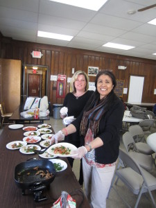 SHA Resident Services Coordinator Candra Cripps, left, and UMass Extension Service Nutritionist Sarifa Khan, right, prepare the healthy lunch.