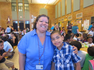 T/R/S! outreach coordinator Zenaida Burgos with Sullivan Apartments resident Nelson Santiago, at opening day of summer learning at Boland Elementary School.