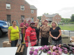 Volunteers from Springfield Housing Authority staff and residents help distribute fresh produce and groceries at Moxon Apartments, a regular stop of the Mobile Food Bank operating by The Food Bank of Western Massachusetts.