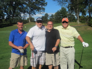 Golfers Chris Tanguay, Keith Barlow, Kevin Kleszczysnki and Wallace Kiesel stop for a smile.