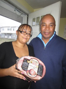 Robison Gardens resident Maria Torres and SHA Youth Engagement Coordinator Jimmie Mitchell show the ham donated by the anonymous giver known as 'the Good Samaritan.'