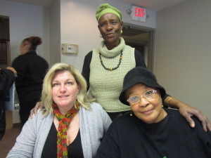 SHA Resident Services Coordinator Candra Cripps sits with Morris Apartments resident Carol Watson. Standing behind them is Springfield Deputy Health and Human Services Commissioner Betty Anderson Frederic. 