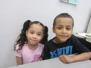 Six-year-old twins Natali and Orlando Morales enjoy the fun at Sullivan Apartments.