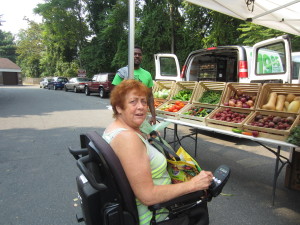 Saab Court resident Kathleen Curley stocks up on fresh produce at the GoFresh Springfield traveling fruit and vegetable stand.