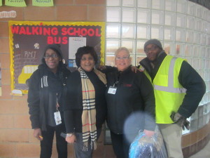 Rebecca Johnson Parent Facilitator, Principal Darcia Milner, and SHA's Rental Assistance Director Blanca Berrios and Family Self-Sufficiency Coordinator Joseph Dumpson. SHA found donations of coats, hats and mittens for children walking to and from the school. 