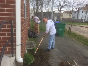 Assistant Property Manager Brad Fink works a rake at the Hancock Street property.