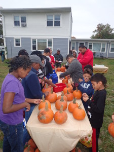 Robinson Gardens neighbors and friends get ready to decorate pumpkins at the community garden celebration.