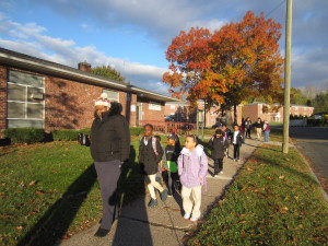 Sullivan Apartments resident Sheena Springer leads the way on the Walking School Bus.