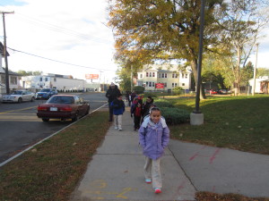 Destiny Garcia, 9, is out front on the walk from Sullivan Apartments to Boland Elementary School.