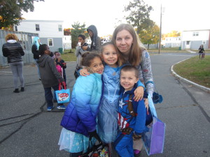 Robinson Gardens resident Kelly Robblets with neighbor Lyric Dupuis and her children Trinity and Gabriel Cousin, trick-or-treating.