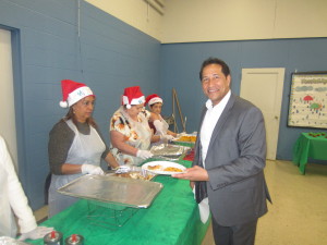 State Rep. Carlos Gonzalez, who co-hosts the event with the Riverview Tenants' Council, delivers lunch with a flourish to elderly residents.