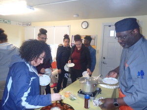 Chef Kelly Dobbins, owner of Iona's Catering in the Indian Orchard section of the city, serves up chili and wings at the Robinson Gardens Youth Group.