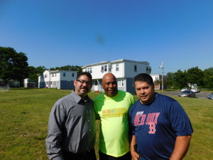 Springfield Fire Lieutenant Marty Burgos, Springfield Housing Authority Youth Engagement Coordinator Jimmie Mitchell, and PhD Juan Hernandez at SHA's Robinson Gardens Apartments.
