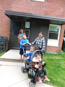 Merary Espada and her children meet with SHA Resident Services Coordinator Daisy Gomez outside the new T/R/S! center at Duggan Park Apartments.