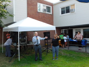 Springfield Housing Authority Executive Director William Abrashkin and T/R/S! Outreach Coordinator Daisy Gomez greet the crowd at Duggan Park Apartments.