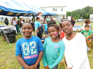 Sisters Brianne, Caitlyn and Alexis Gasque, ages 8, 7 and 10, show off their painted faces at Robinson Gardens.
